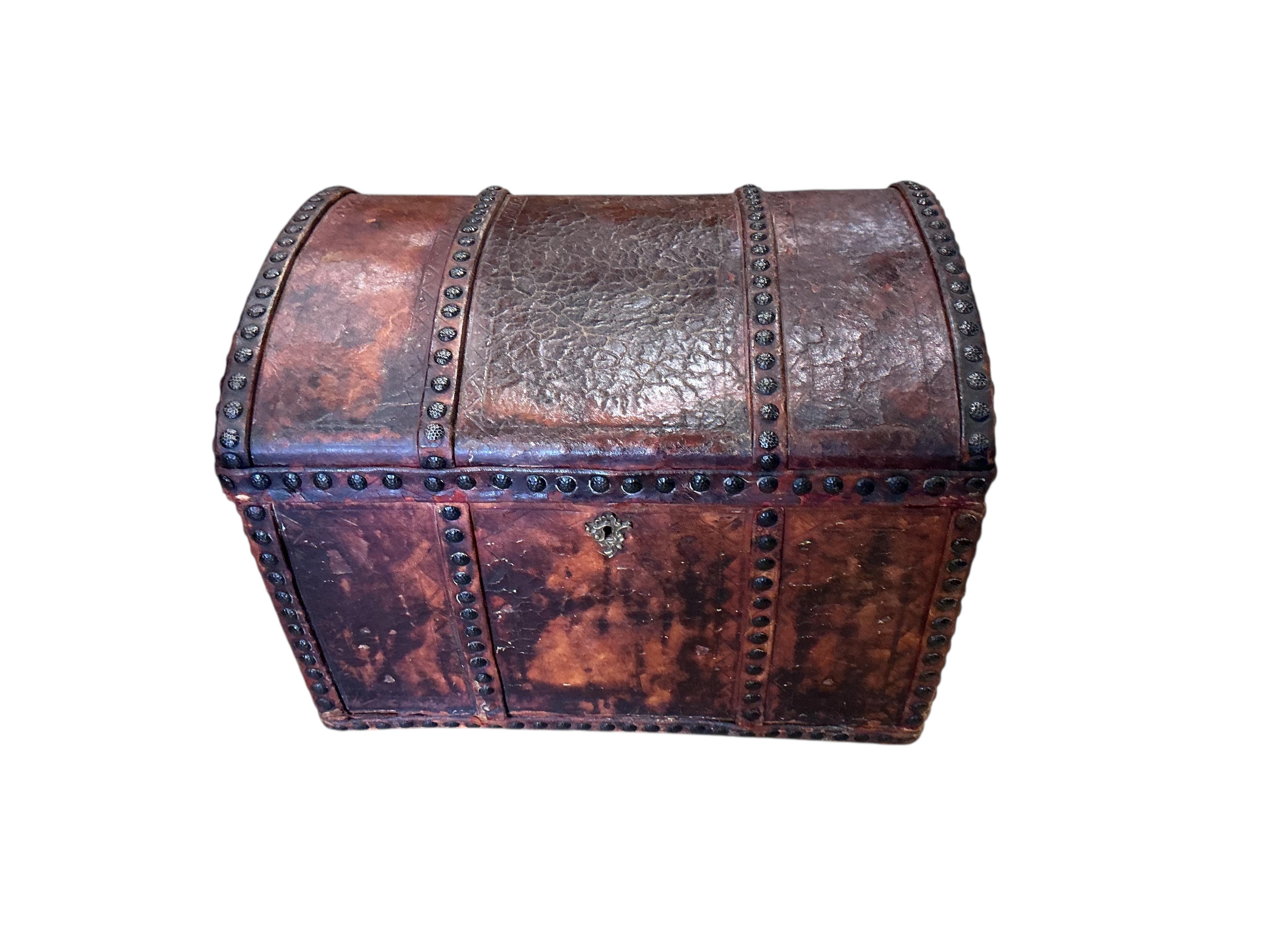 A small 18th century style studded domed top leather covered trunk with internal drawers, width 50cm, depth 35cm, height 37cm